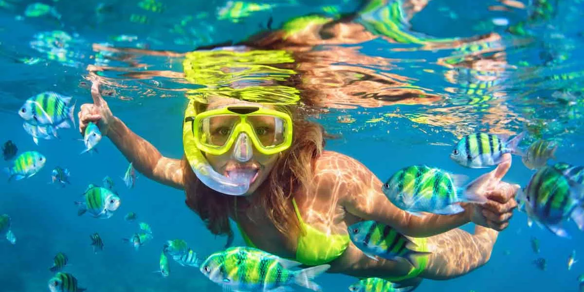 Young Woman Diving Underwater Wearing Snorkeling Mask